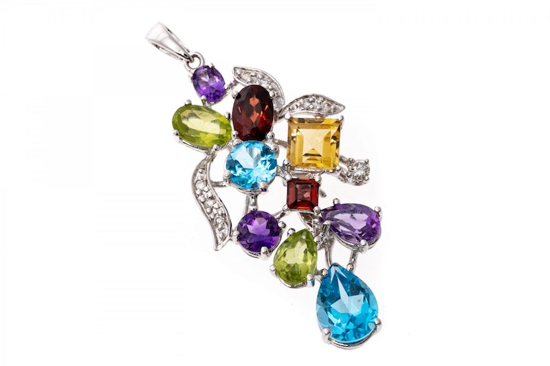 This cheerful pendant is a grape cluster motif, set with multiple shaped and sized semi precious stones, including London blue color blue topaz (app. 1.59 TCW), purple amethysts (app. 0.61 TCW), chartreuse green color peridot (app. 0.62 TCW), golden yellow citrine (app. 0.40 CTS) and burgundy garnets (app. 0.56 TCW). 
